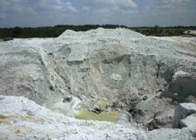 Illegal miners work in an open air pit tin mine on Bangka is
