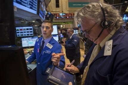 Wall St finishes flat on caution before U.S. jobs data